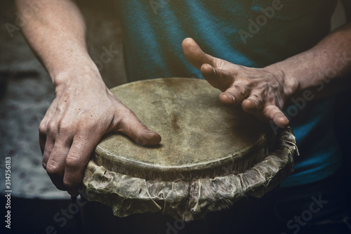 ethnic percussion musical instrument jembe and male hands