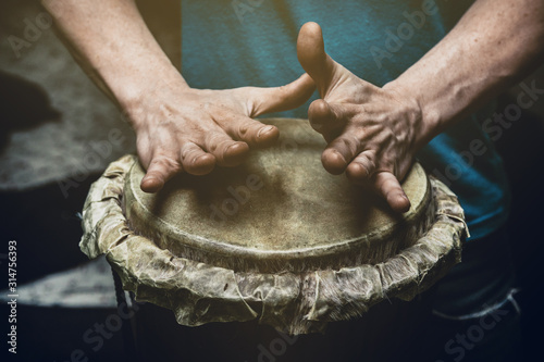 ethnic percussion musical instrument jembe and male hands