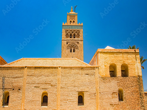 Koutoubia Mosque minaret at medina quarter of Marrakesh, Morocco. Blue sky is in the background. photo