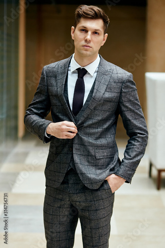 Beautiful gentleman in grey suit look at camera. People, fashion concept