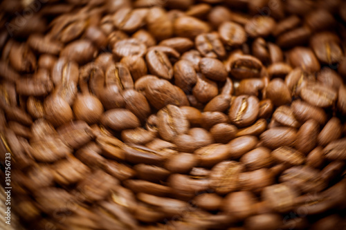 Premium quality light roasted coffee beans rotating. Close up of brown roasted coffee beans