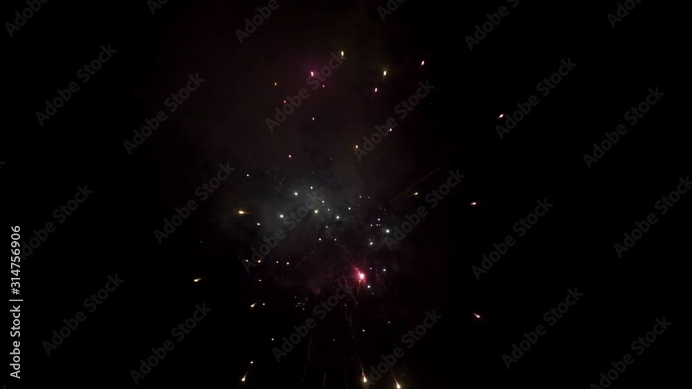 Bright fireworks explode in the dark night sky.holiday screensaver for your design Bright fireworks explode in the dark night sky.holiday screensaver for your design