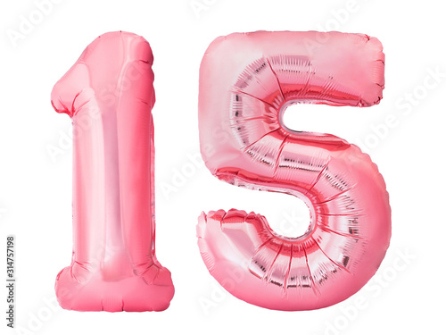 Number 15 fifteen made of rose gold inflatable balloons isolated on white background. Pink helium balloons forming 15 fifteen number