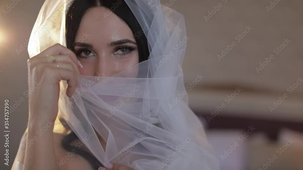 Beautiful and lovely bride in night gown and veil. Wedding morning. Slow motion Beautiful and lovely bride in night gown and veil. Wedding morning. Slow motion