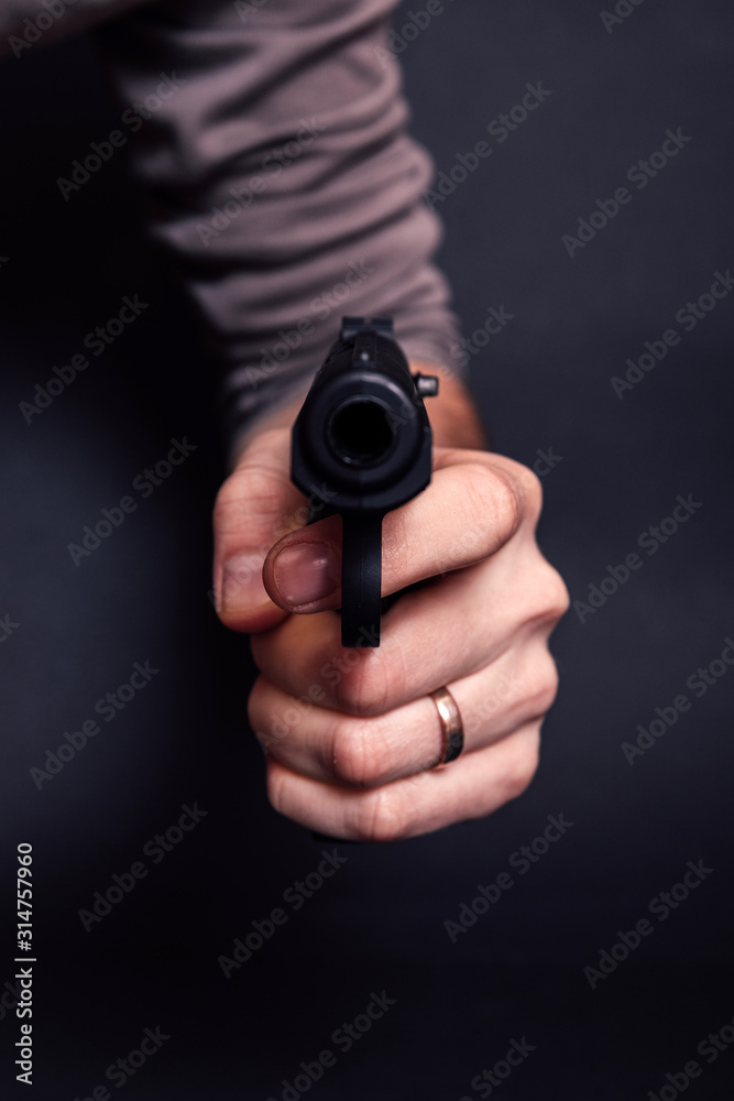 Male hand with gun isolated on black background. Man with a gun ready to shoot, focus on the weapon. Male hand with gun isolated on black background. Man with a gun ready to shoot, focus on the weapon.