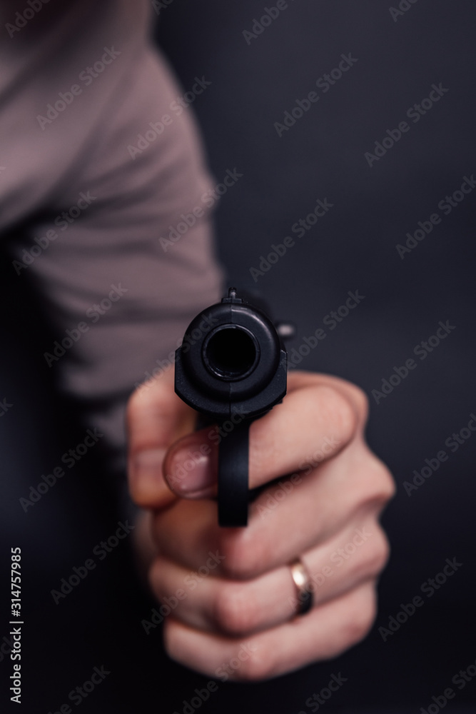 Male hand with gun isolated on black background. Man with a gun ready to shoot, focus on the weapon. Male hand with gun isolated on black background. Man with a gun ready to shoot, focus on the weapon.