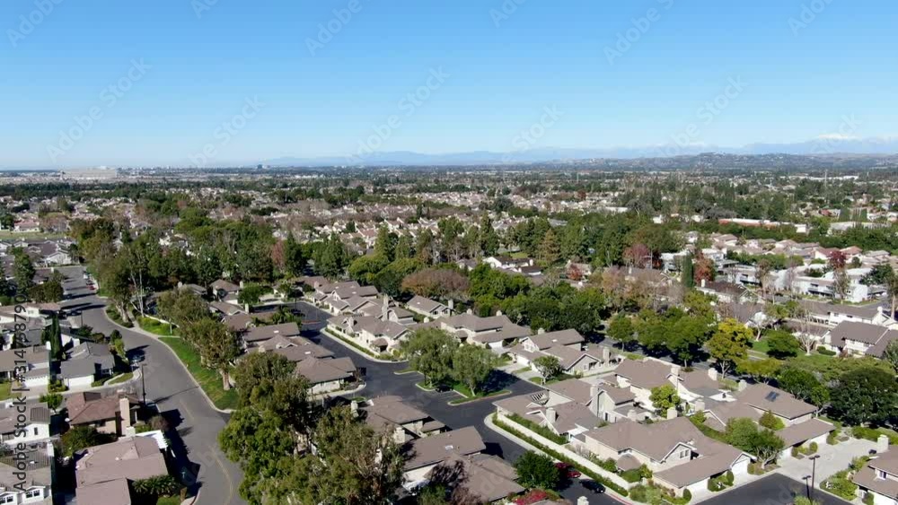 Aerial view of residential suburban packed homes neighborhood during blue sky day in Irvine, Orange County, USA Aerial view of residential suburban packed homes neighborhood during blue sky day in Irvine, Orange County, USA