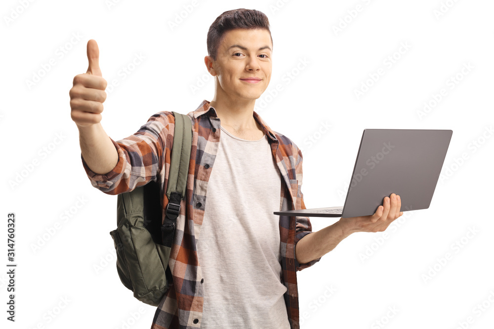 Male student gesturing a thumb up and holding a laptop computer Male student gesturing a thumb up and holding a laptop computer