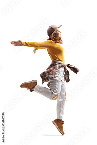 Young woman in casual clothes dancing and jumping