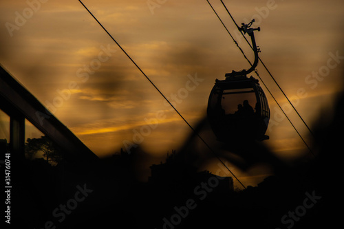 Cable car with passengers at sunset