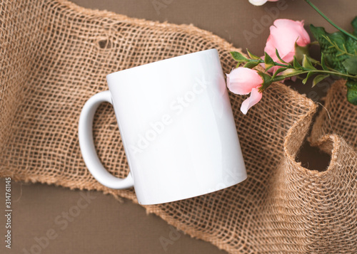 Rustic Elegance: Blank White Mug Mockup Set Against a Warm Brown and Burlap Backdrop photo