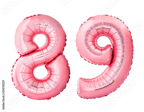 Number 89 eighty nine of rose gold inflatable balloons isolated on white background. Pink helium balloons forming 89 eighty nine number photo