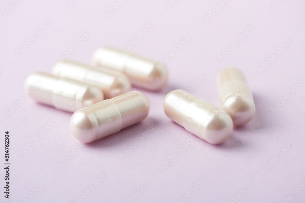 Carnitine capsules. Concept for a healthy dietary supplementation. Bright paper background. Soft focus. Close up. Carnitine capsules. Concept for a healthy dietary supplementation. Bright paper background. Soft focus. Close up.