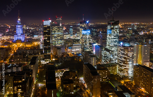 Aerial view of bright lights and nightlife in the business center of Warsaw-Poland. 03. December. 2019. Drone fired at a city at night with skyscrapers in the fog in the business district of Warsaw.