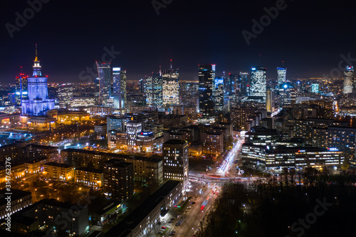 Warsaw-Poland 04. December. 2019. Aerial view of luminous high-rise buildings of the business center with lighted windows located in Warsaw against the evening sky. 