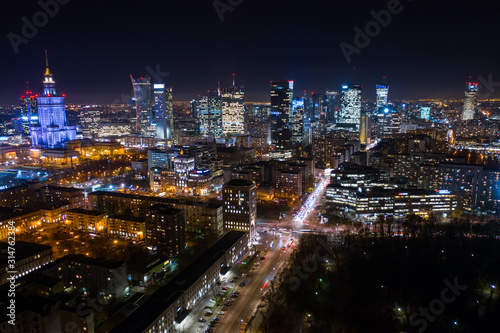 Drone fired at a city at night with skyscrapers in the business district of Warsaw. Poland. 03. December. 2019. Aerial view of bright lights and nightlife in the business center of Warsaw.