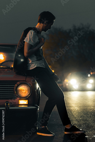 man on street in the city with oldschool car