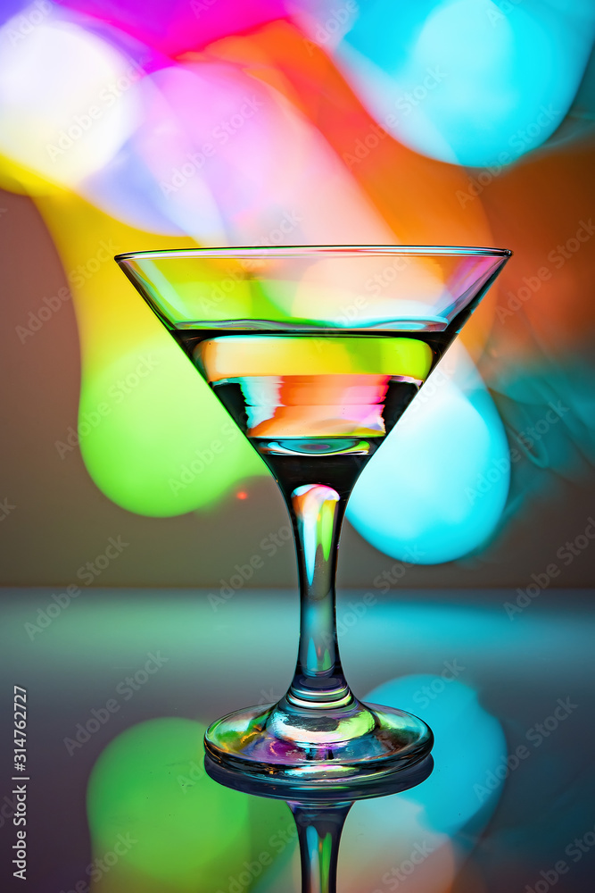 a glass of martini on a multicolor background a glass of martini on a multicolor background