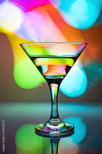 a glass of martini on a multicolor background