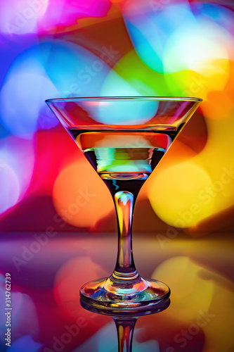 a glass of martini on a multicolor background
