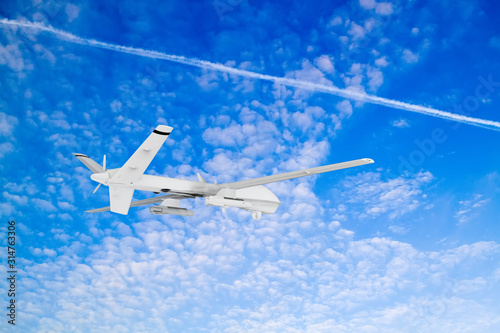 military RC military drone flies against the backdrop of blue peaceful sky with white clouds