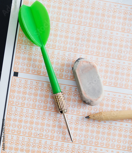 exam paper, dart and exam pen eraser together,
