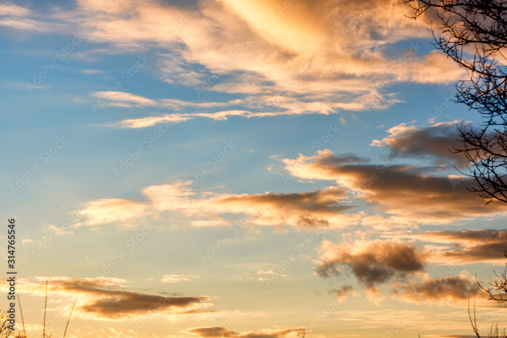 Obraz premium Bright sunset on the background of cloudy sky.