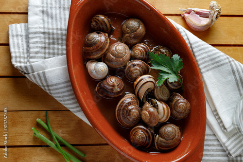 Snails with garlic and parsley photo