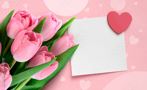 Valentine Mother's day greeting card with pink tulips and blank paper note with heart on pink background.