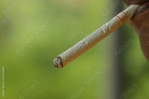 man smoking Indonesian kretek cigarette