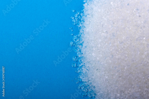 white granulated sugar on an blue background