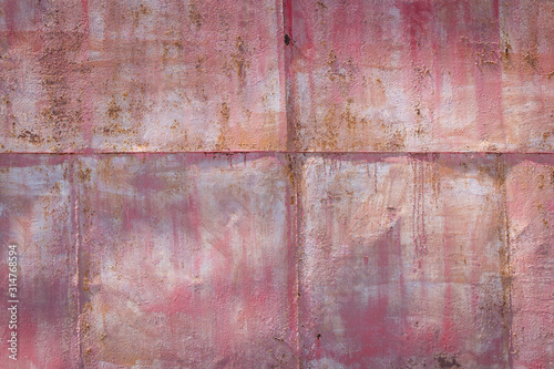 pink background of a painted rusty metal surface 