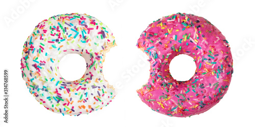 Set of two bitten donuts decorated with colorful sprinkles isolated on white background