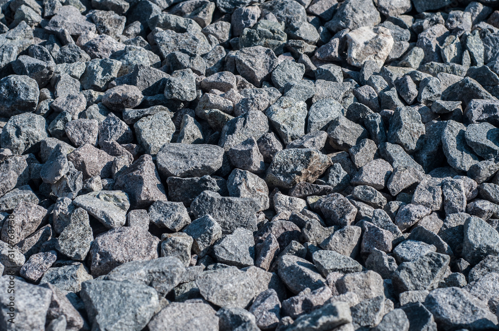 Gray limestone gravel closeup in sunny day Gray limestone gravel closeup in sunny day
