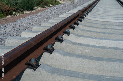 New railway rails with concrete sleepers closeup