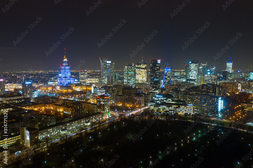 Warsaw-Poland 04. December. 2019. Aerial view of luminous high-rise buildings of the business center with lighted windows located in Warsaw against the evening sky. 