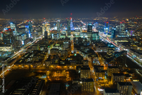 Wallpaper Mural Warsaw-Poland 04. December. 2019. Aerial view of luminous high-rise buildings of the business center with lighted windows located in Warsaw against the evening sky.  Torontodigital.ca