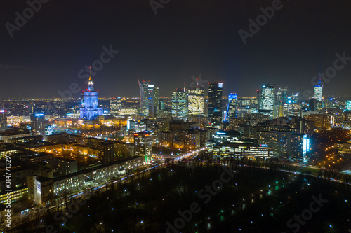 Wallpaper Mural Warsaw-Poland 04. December. 2019. Aerial view of luminous high-rise buildings of the business center with lighted windows located in Warsaw against the evening sky.  Torontodigital.ca