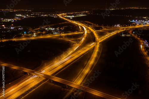 Aerial view of the night freeway with intersections, bridges and viaducts.