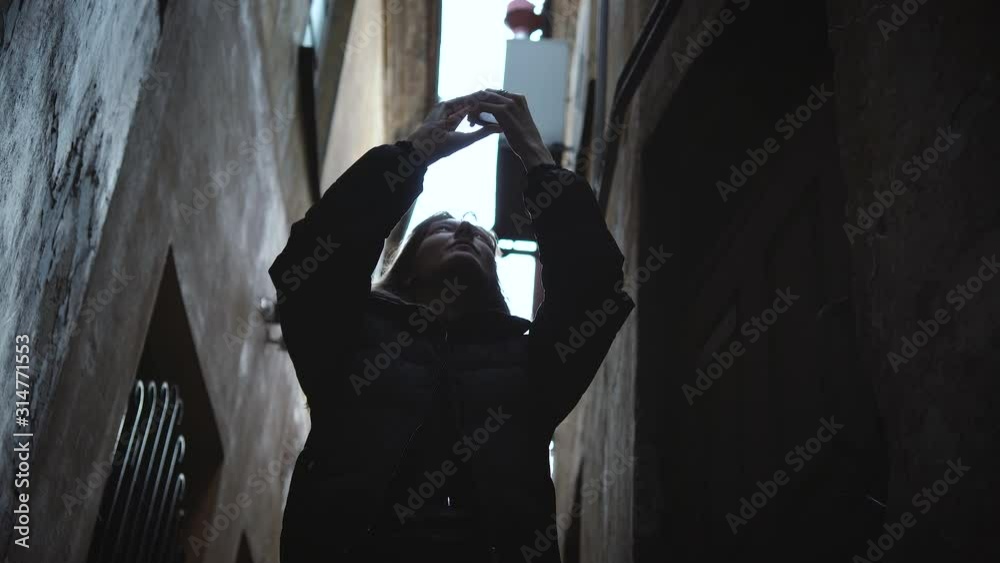 Woman blogger traveler making selfie in old town among low-rise buildings. Woman blogger traveler making selfie in old town among low-rise buildings.
