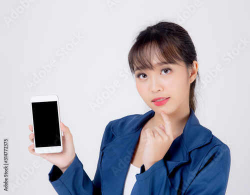 Beautiful young business asian woman show blank smart mobile phone isolated on white background, businesswoman presenting smartphone for advertising, girl holding phone, communication concept.