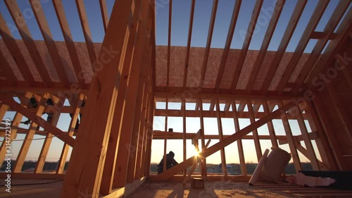 Wallpaper Mural Timelapse, view from below of unfinished frame house interior and builders covering roof with waterproofing layer. Sunny day Torontodigital.ca