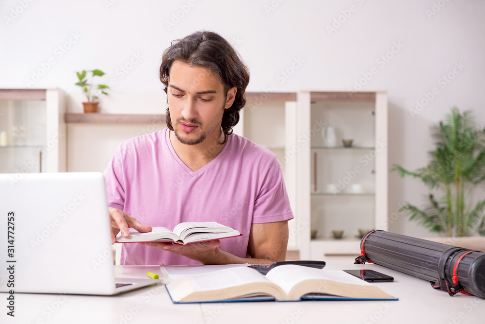 Young male student preparing for exams at home Young male student preparing for exams at home