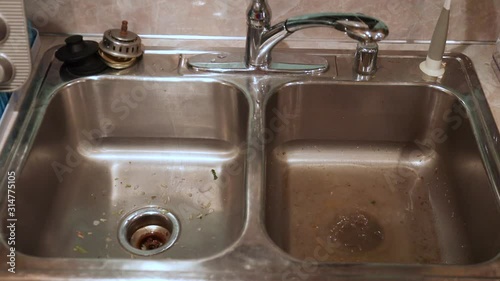 Plumbing Problem in Kitchen Dual Sink Full of Water and Broken Garbage Disposal photo