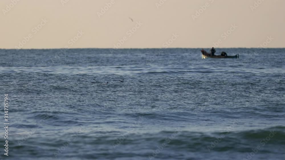Sailing fishing boat and beautiful sea sunrise