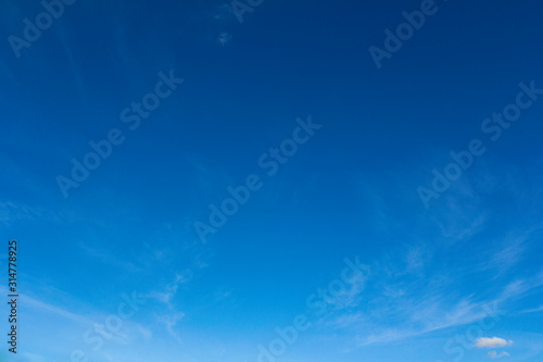 Clear blue sky with clouds for background picture. © Alexlekky