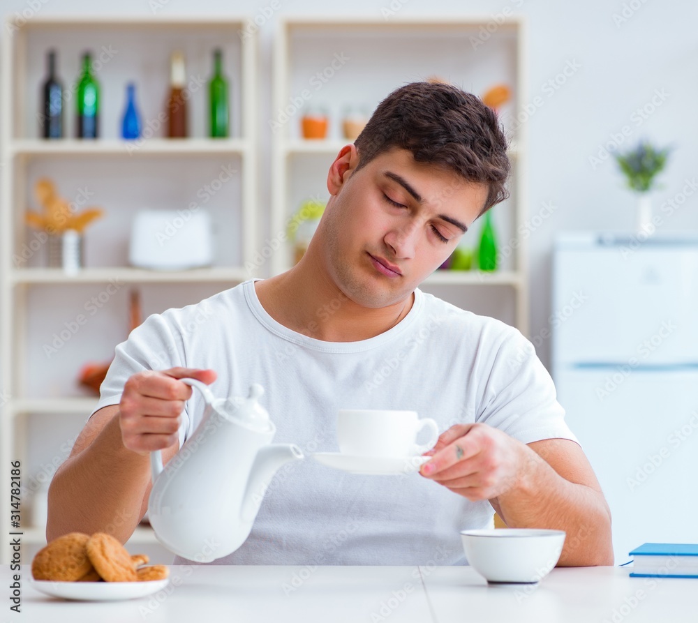 Man falling asleep during his breakfast after overtime work Man falling asleep during his breakfast after overtime work