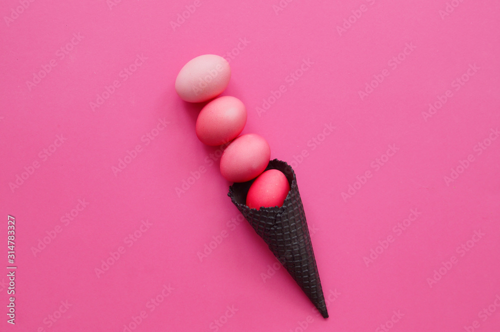 The eggs roll out of the black horn. Pink background. The eggs roll out of the black horn. Pink background.