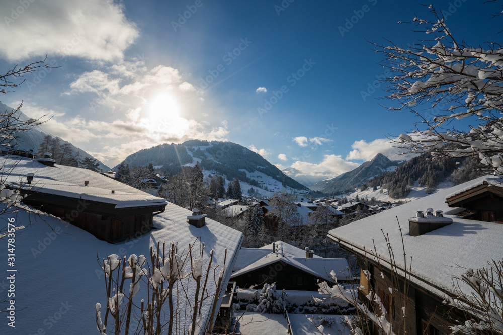 Gstaad, Switzerland - 01.01.2019: Winter view of snow covered roofs