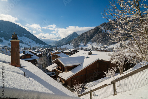 Gstaad, Switzerland - 01.01.2019: Winter view of snow covered roofs.